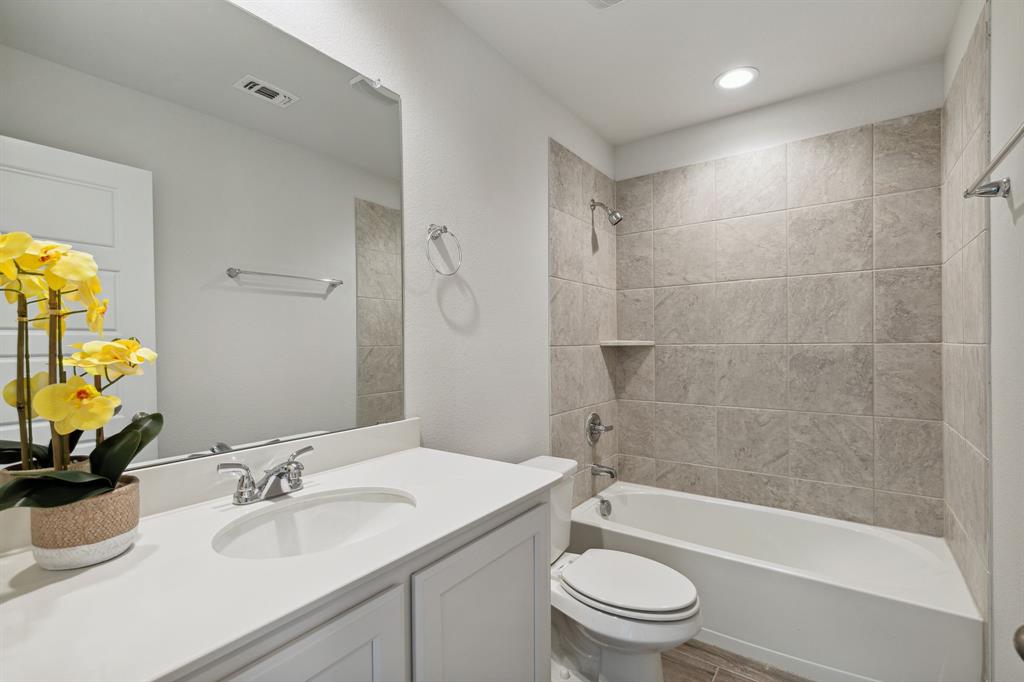 6028 Bursey Road Watauga, TX 76148 - Photo 25 of 27 a bathroom with a sink a toilet and shower