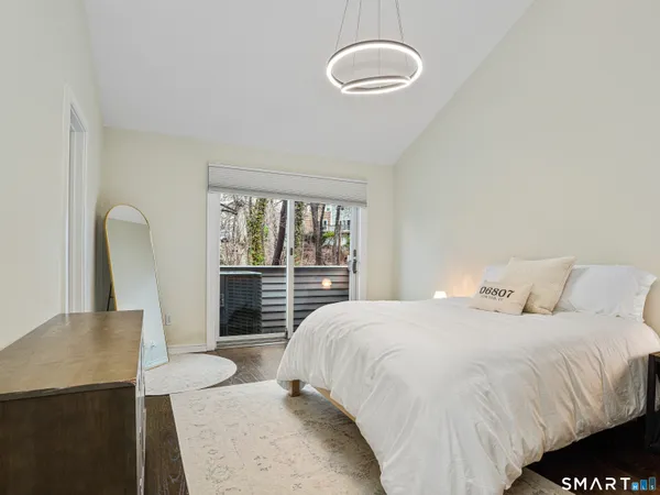 a bedroom with a bed and a large window