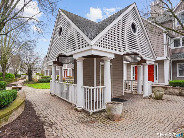 a front view of a house with a garden and plants