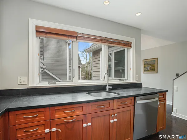 a kitchen with granite countertop sink and cabinets