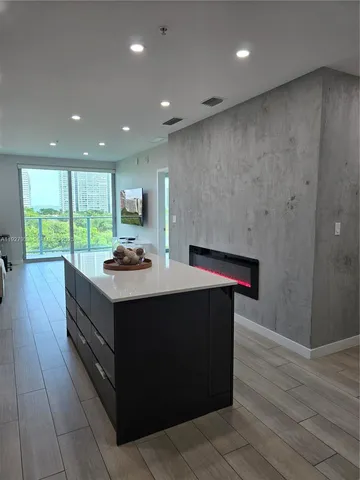 a kitchen with kitchen island a sink stainless steel appliances and cabinets