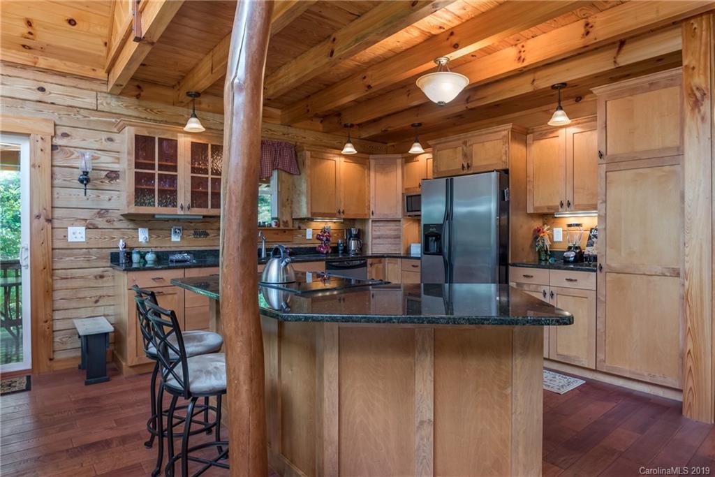 83 Cross Ridge Drive Rutherfordton, NC 28139 - Photo 12 of 38 a kitchen with refrigerator and chairs