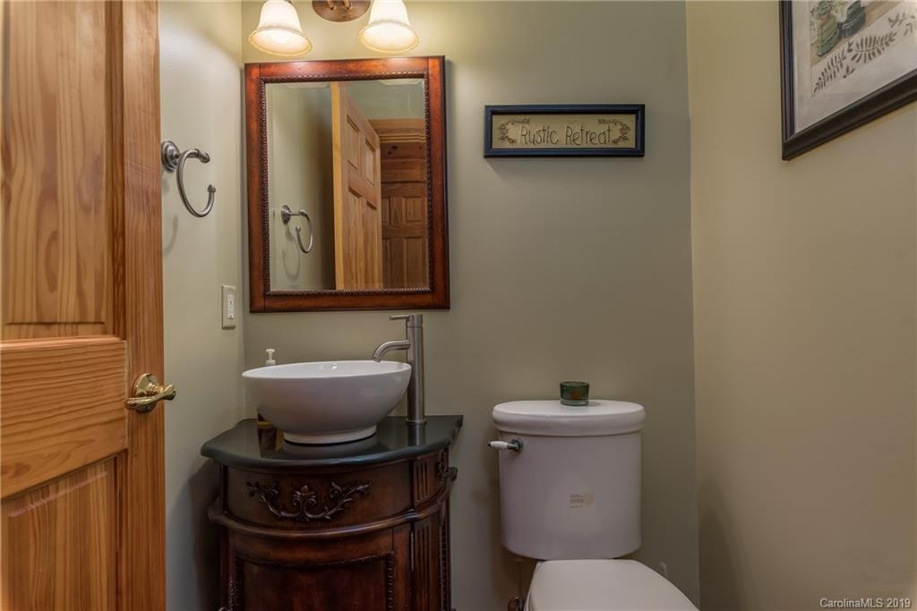 83 Cross Ridge Drive Rutherfordton, NC 28139 - Photo 22 of 38 a bathroom with a toilet a sink and mirror