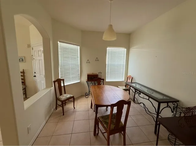 a view of a dining room with furniture and window