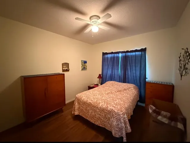 a bed sitting in a room next to a wooden cabinet