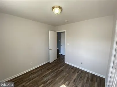 a view of a room with wooden floor and fan