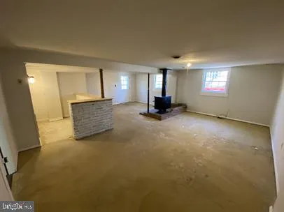 a view of an empty room with a fireplace