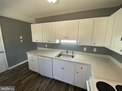 a kitchen with a sink and cabinets