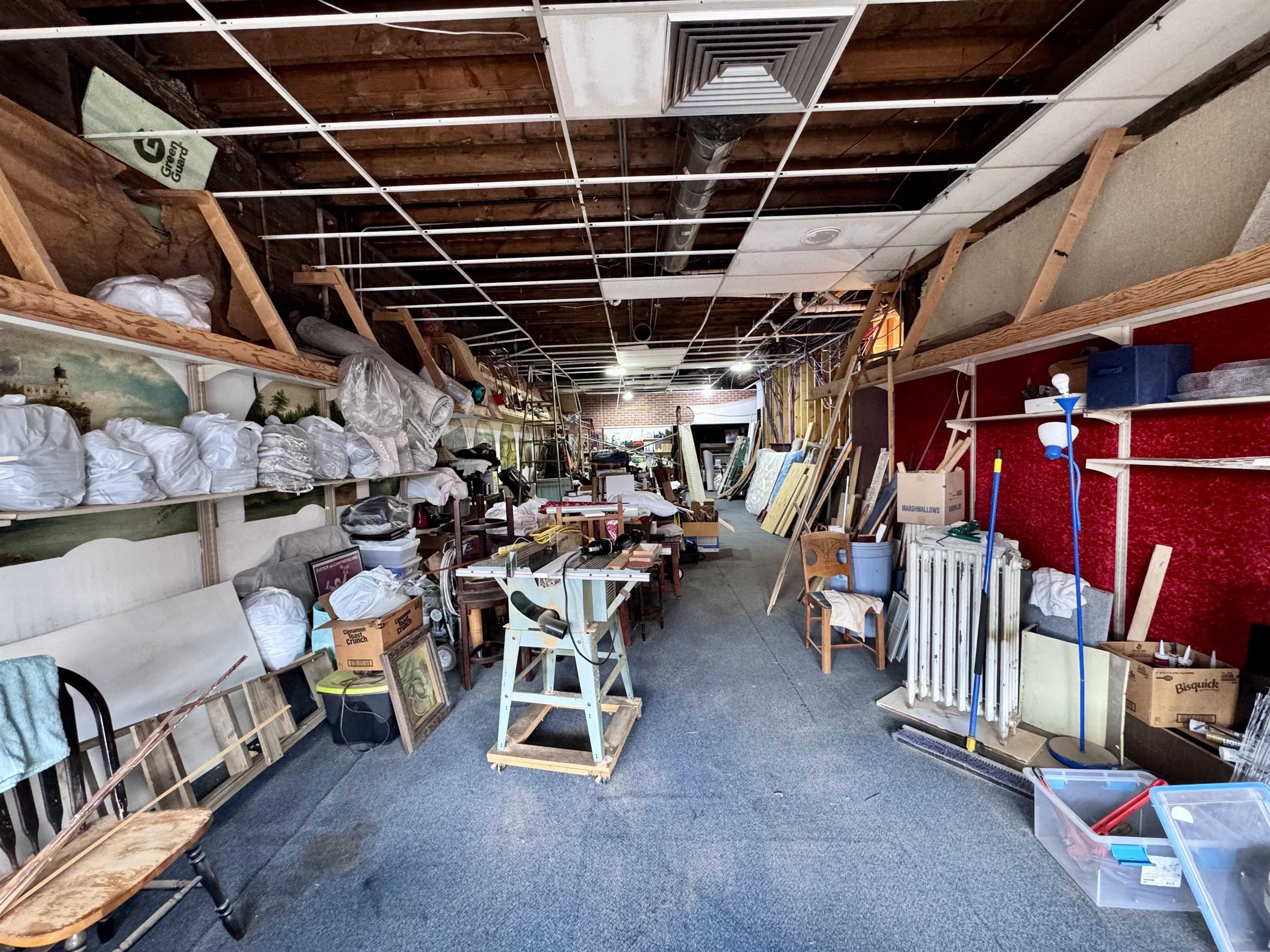 601 1st Avenue Two Harbors, MN 55616 - Photo 16 of 99 Commercial space currently used as the storage side of the rental space featuring original artist paintings on the plaster walls and available vacation rental inventory.