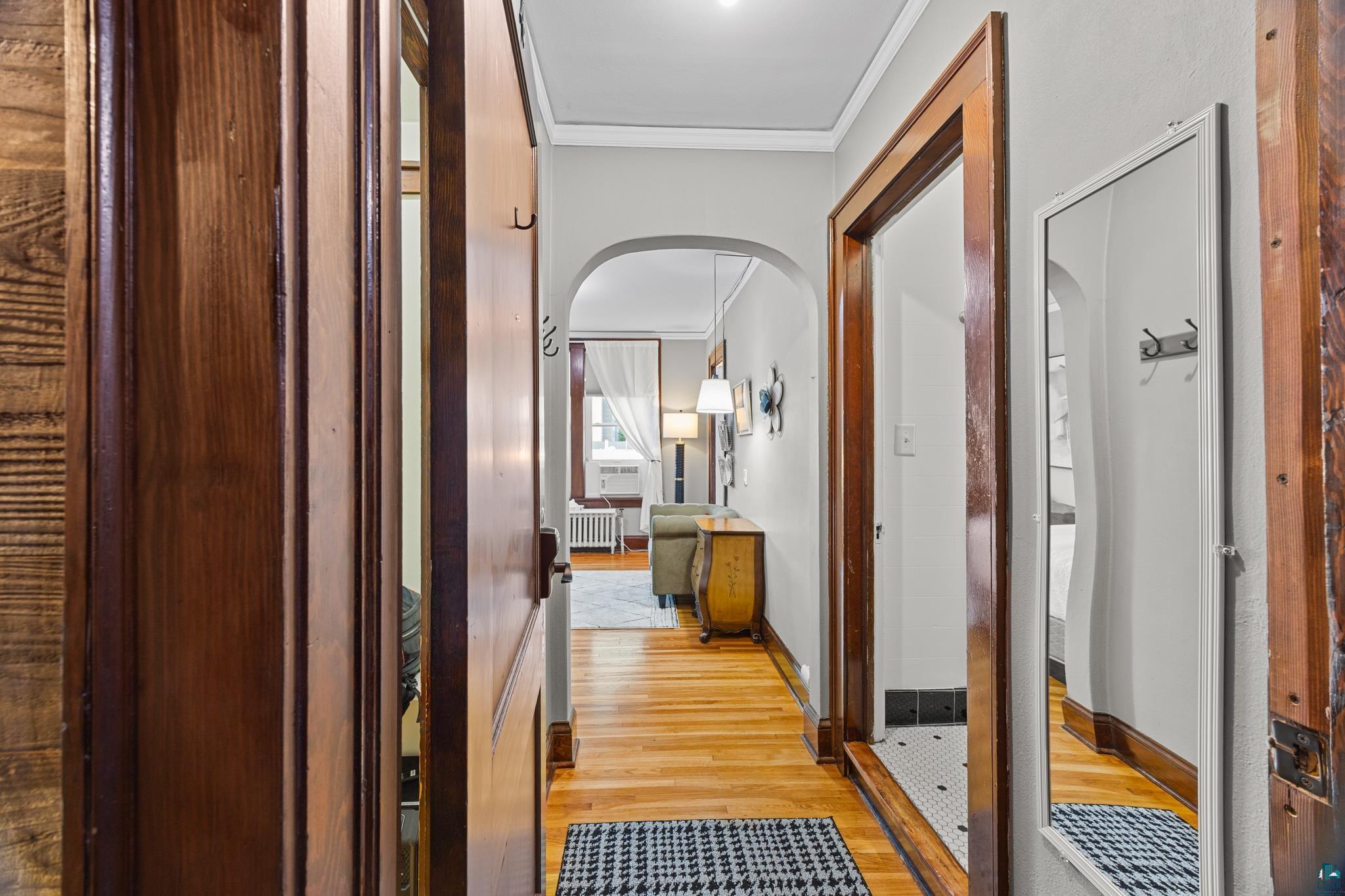 601 1st Avenue Two Harbors, MN 55616 - Photo 63 of 99 Featuring Douglas fir trim, light oak floors, and an arched doorway