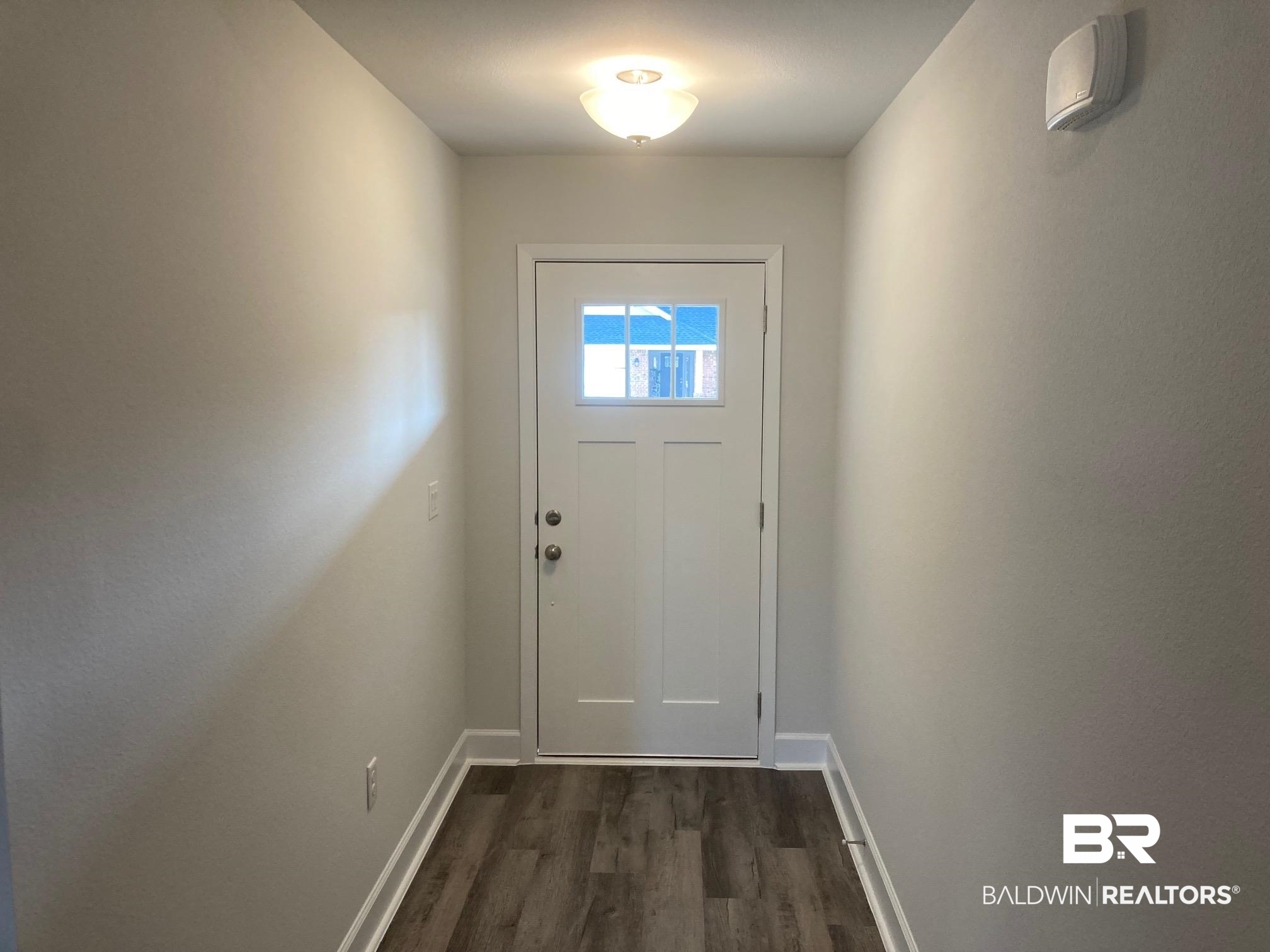 629 Revere Street Foley, AL 36535 - Photo 4 of 30 Doorway with dark hardwood / wood-style floors