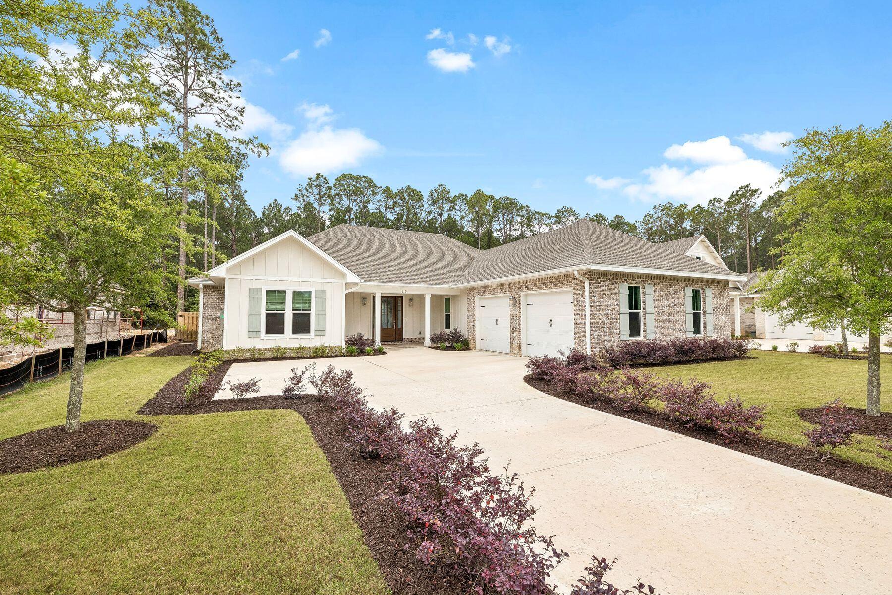 39 West Captain Fritz Way Freeport, FL 32439 - Photo 2 of 33 a front view of a house with a yard and trees