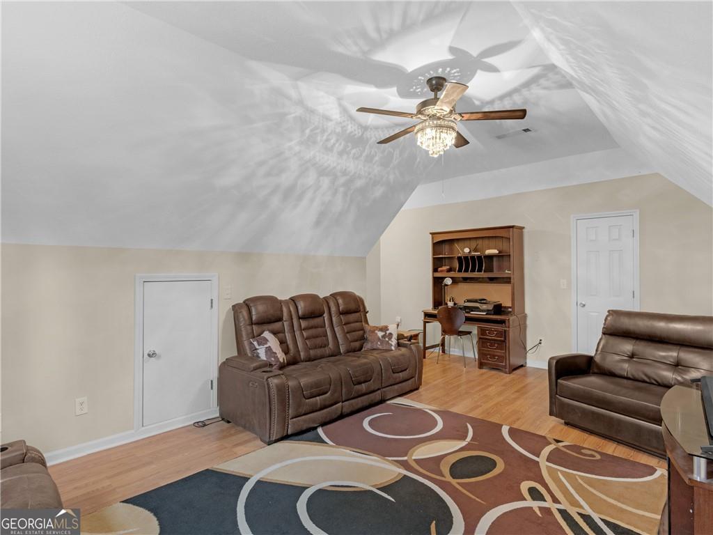 355 Parker Road Covington, GA 30014 - Photo 40 of 60 a living room with furniture and wooden floor
