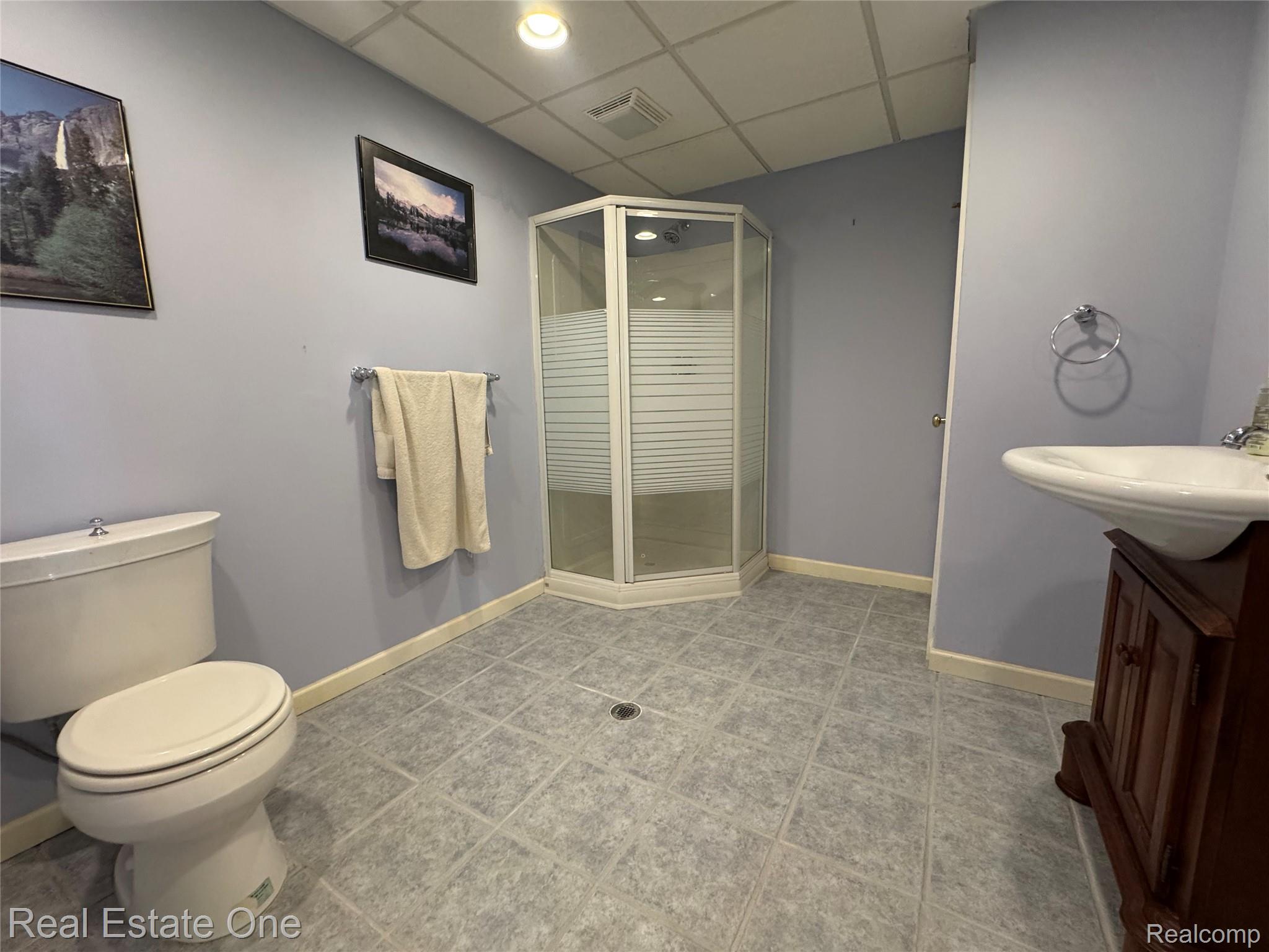 1668 South Shore Drive Rochester, MI 48307 - Photo 24 of 27 Full bathroom featuring a paneled ceiling, a stall shower, vanity, light tile patterned floors, and recessed lighting