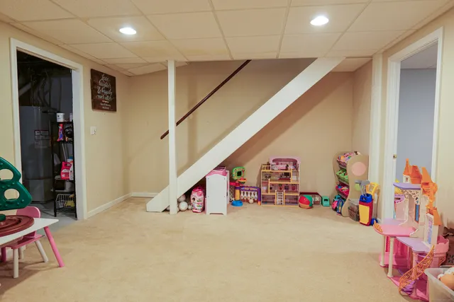 a play room with furniture and wooden floor