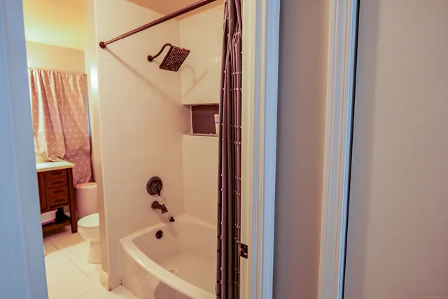 a bathroom with a bathtub and a shower
