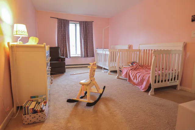 a spacious bedroom with a bed and a window