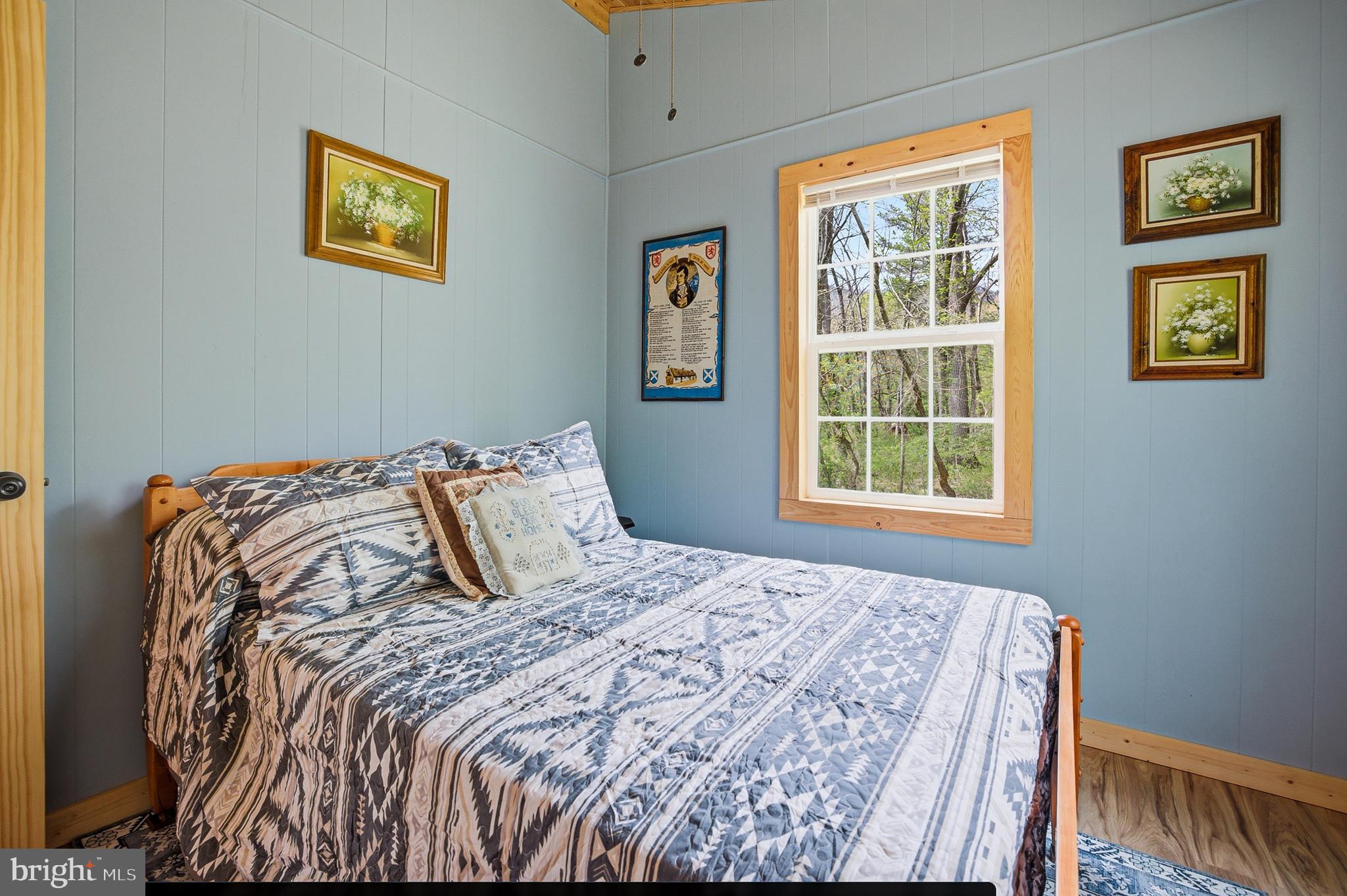 789 Mill Run Road Shenandoah, VA 22849 - Photo 20 of 76 a bed sitting in a bedroom next to a window