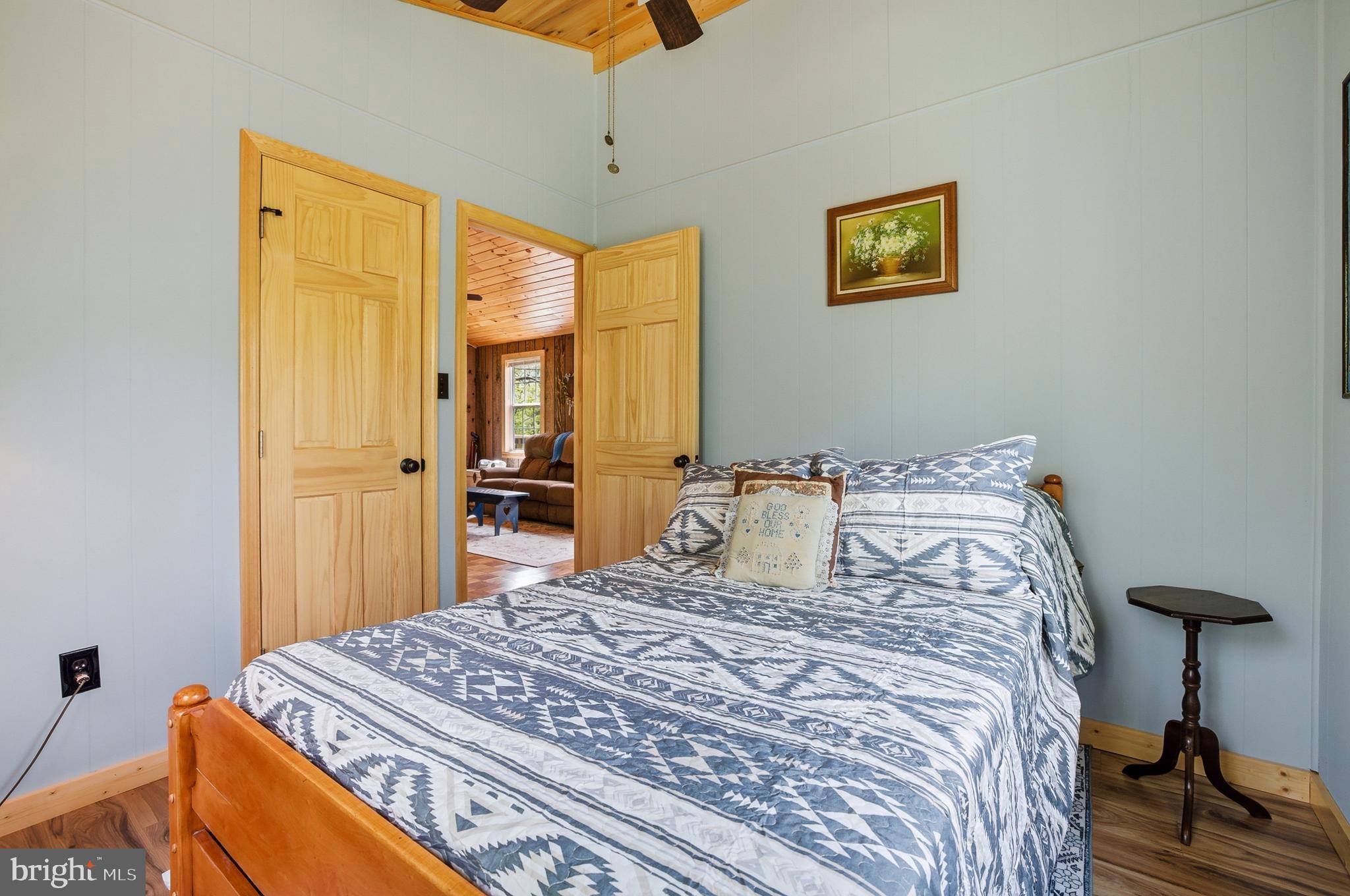 789 Mill Run Road Shenandoah, VA 22849 - Photo 21 of 76 a bedroom with a bed and a chandelier