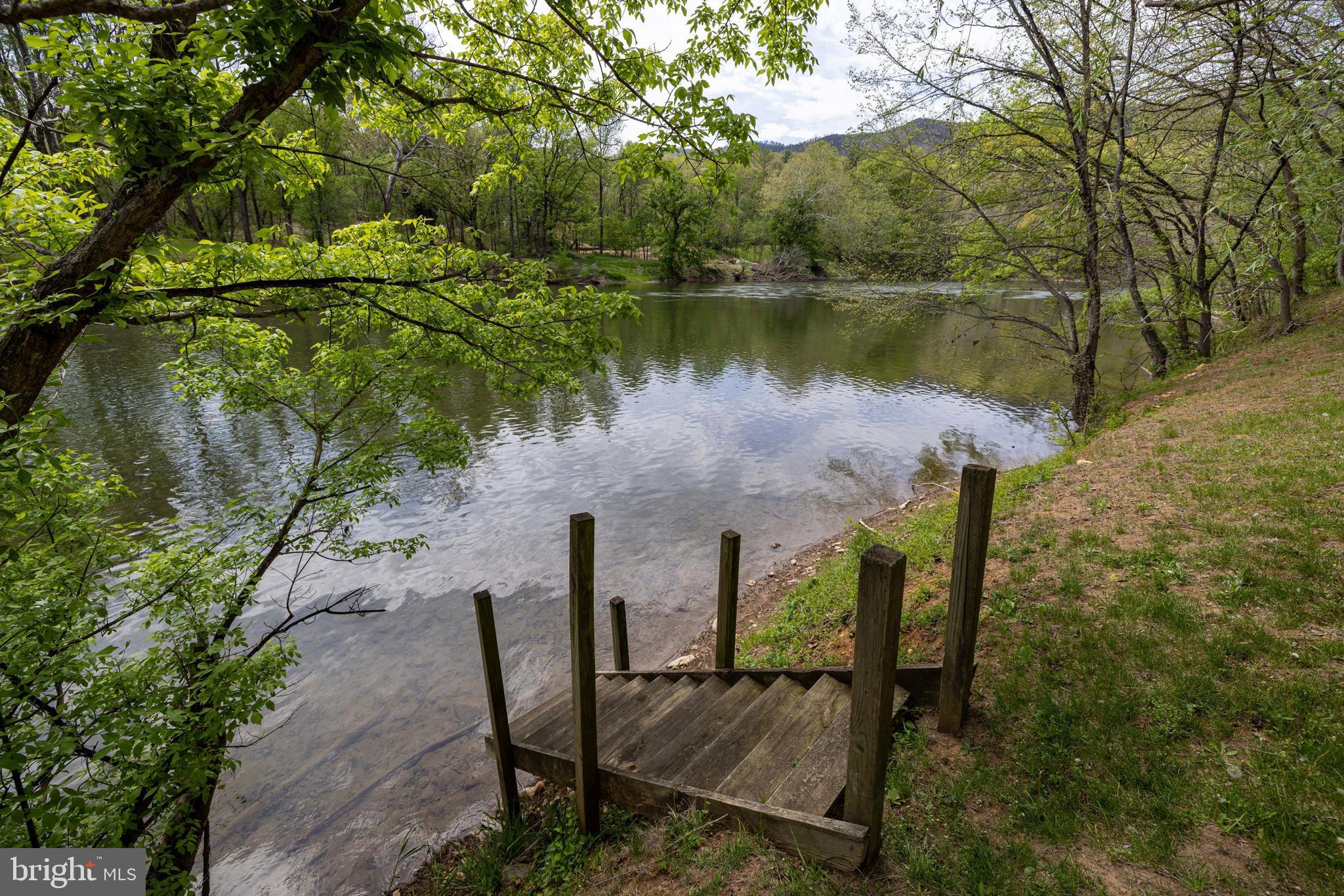 789 Mill Run Road Shenandoah, VA 22849 - Photo 3 of 76 a view of a lake with table and chairs