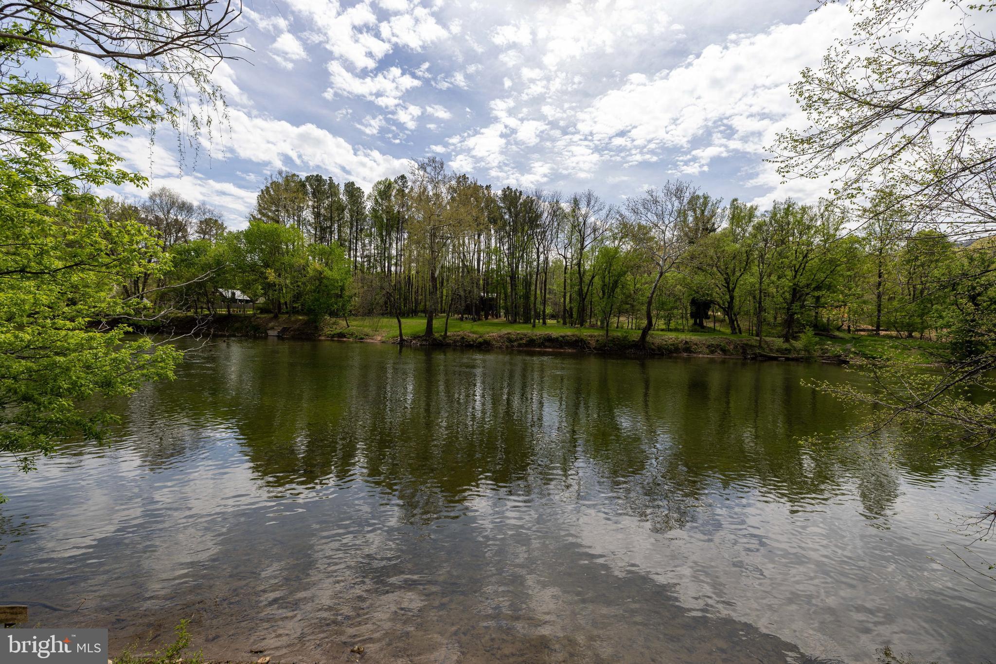 789 Mill Run Road Shenandoah, VA 22849 - Photo 33 of 76 a view of a lake with houses in the background