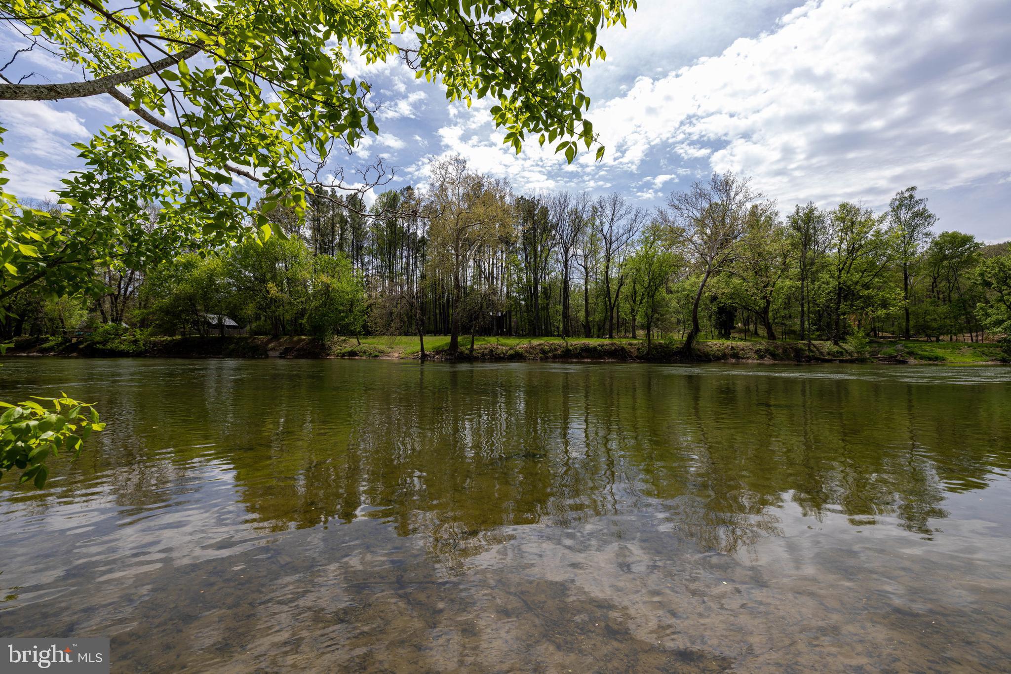 789 Mill Run Road Shenandoah, VA 22849 - Photo 35 of 76 a view of a lake with a yard and trees