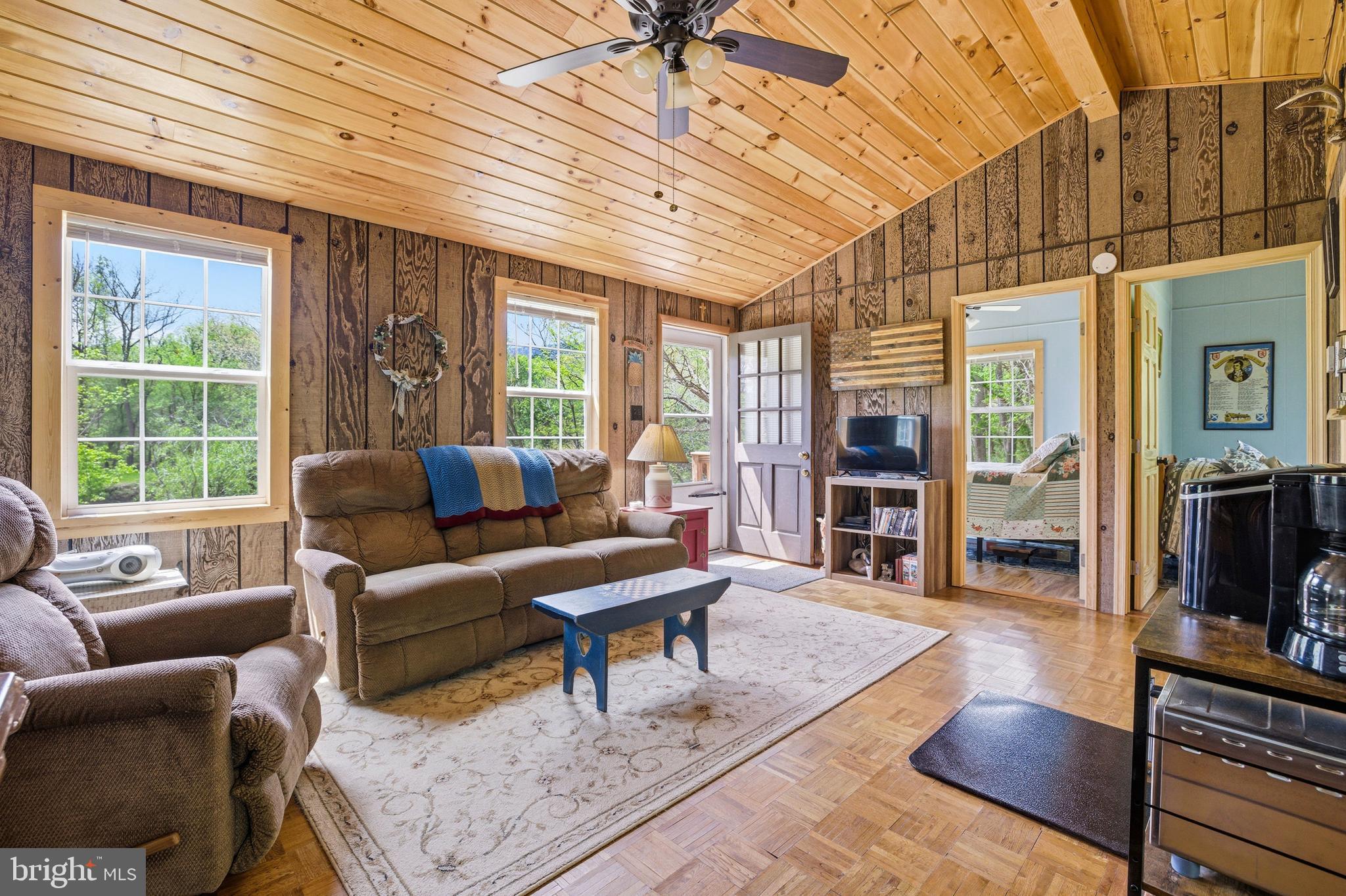 789 Mill Run Road Shenandoah, VA 22849 - Photo 9 of 76 a living room with furniture a wooden floor and a large window