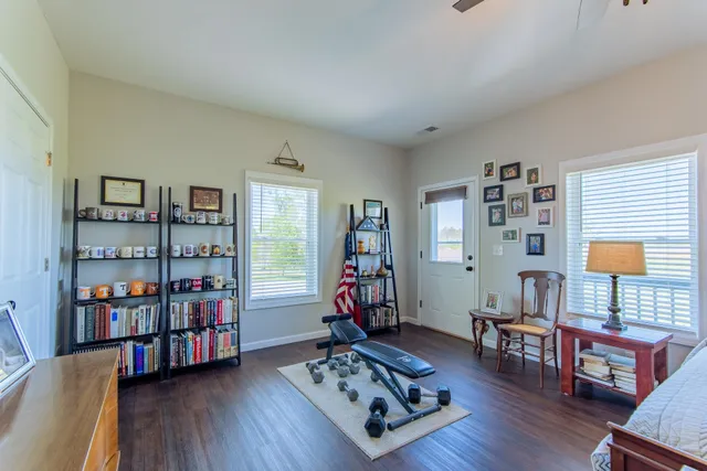 a living room with lots of furniture and wooden floor