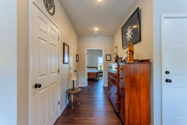 a view of a hallway view with wooden floor and staircase