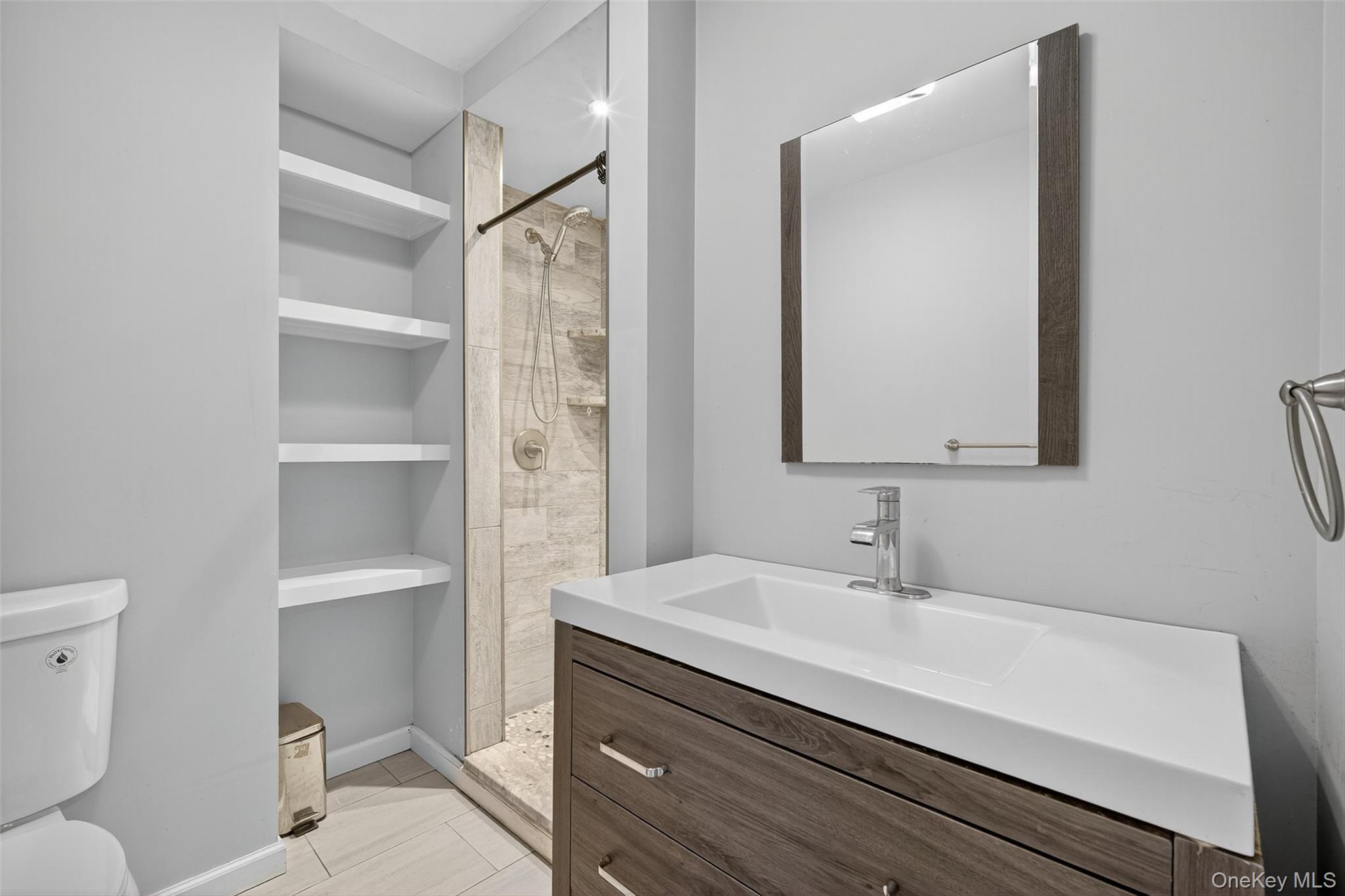 24 Fairview Road Mahopac, NY 10541 - Photo 11 of 26 a bathroom with a sink a toilet a shower and a mirror