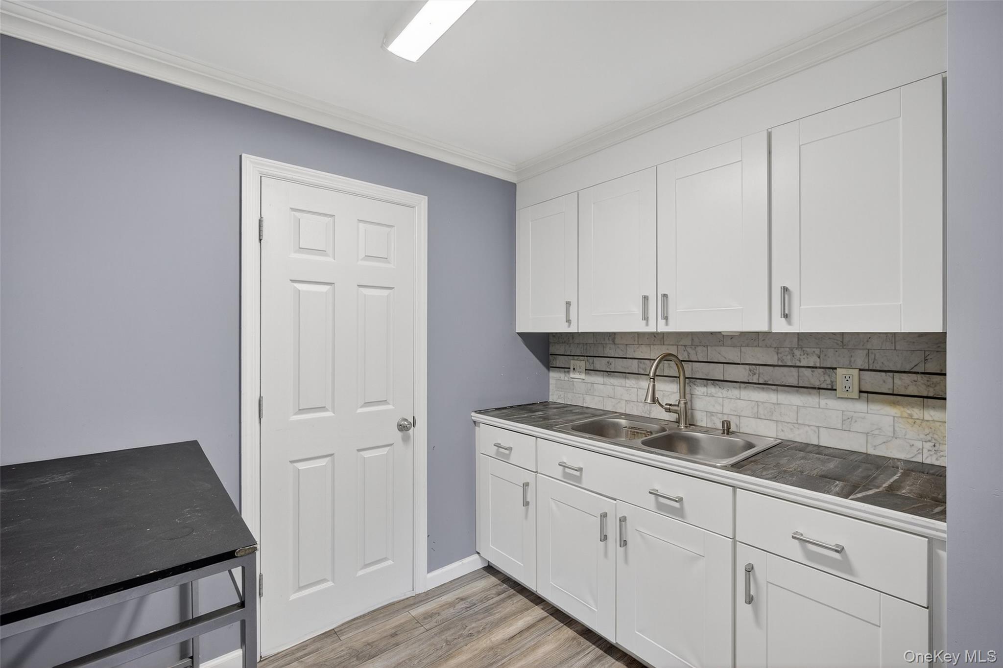 24 Fairview Road Mahopac, NY 10541 - Photo 4 of 26 a kitchen with granite countertop white cabinets and sink