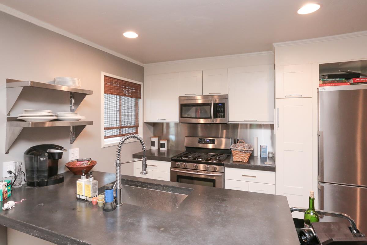 3245 Roop Road Gilroy, CA 95020 - Photo 19 of 35 a kitchen with a refrigerator and a stove top oven