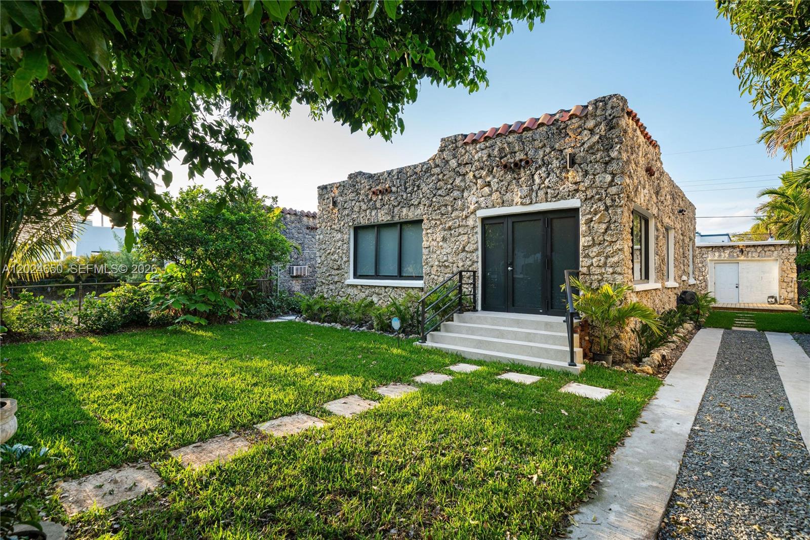 1663 Southwest 13th Street Miami, FL 33145 - Photo 3 of 112 a front view of a house with garden