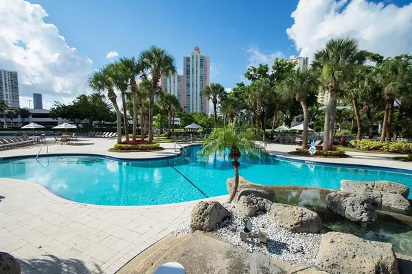 a view of a swimming pool with outdoor seating