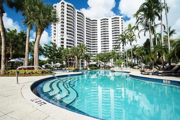 a view of swimming pool with outdoor seating and plants