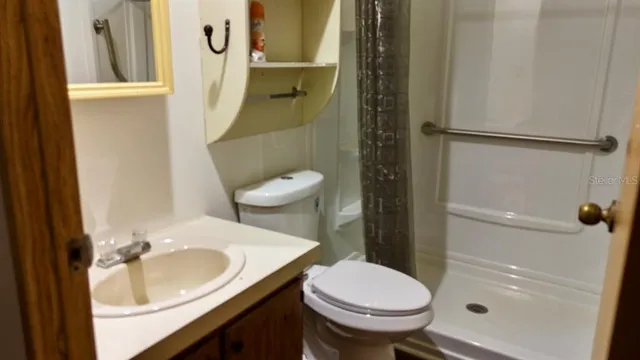 a bathroom with a sink toilet and shower