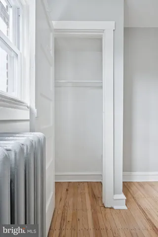 a view of a room with wooden floor and a window