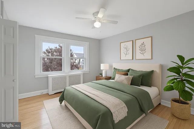 a bedroom with a large bed and a window