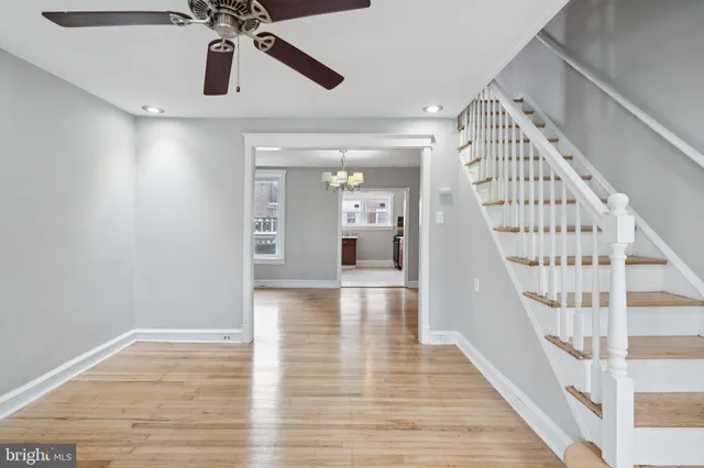 a view of a hallway view with wooden floor and staircase
