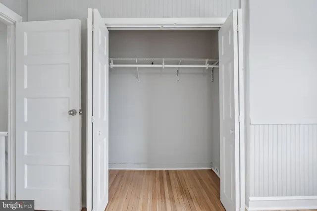 a view of a room with wooden floor