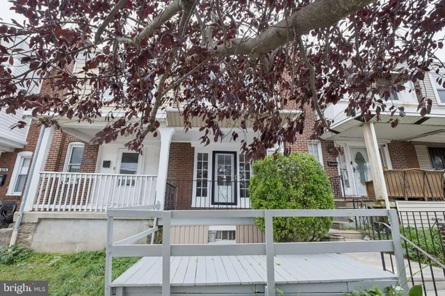 front view of a house with a tree