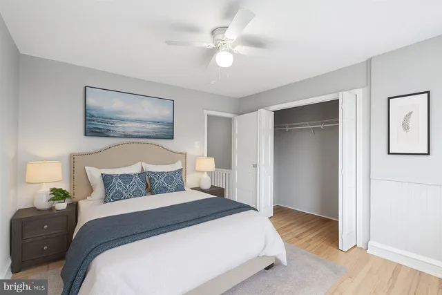 a bedroom with a bed and a painting on the wall