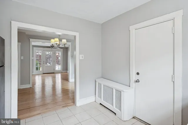 a view of a hallway with white walls and entryway