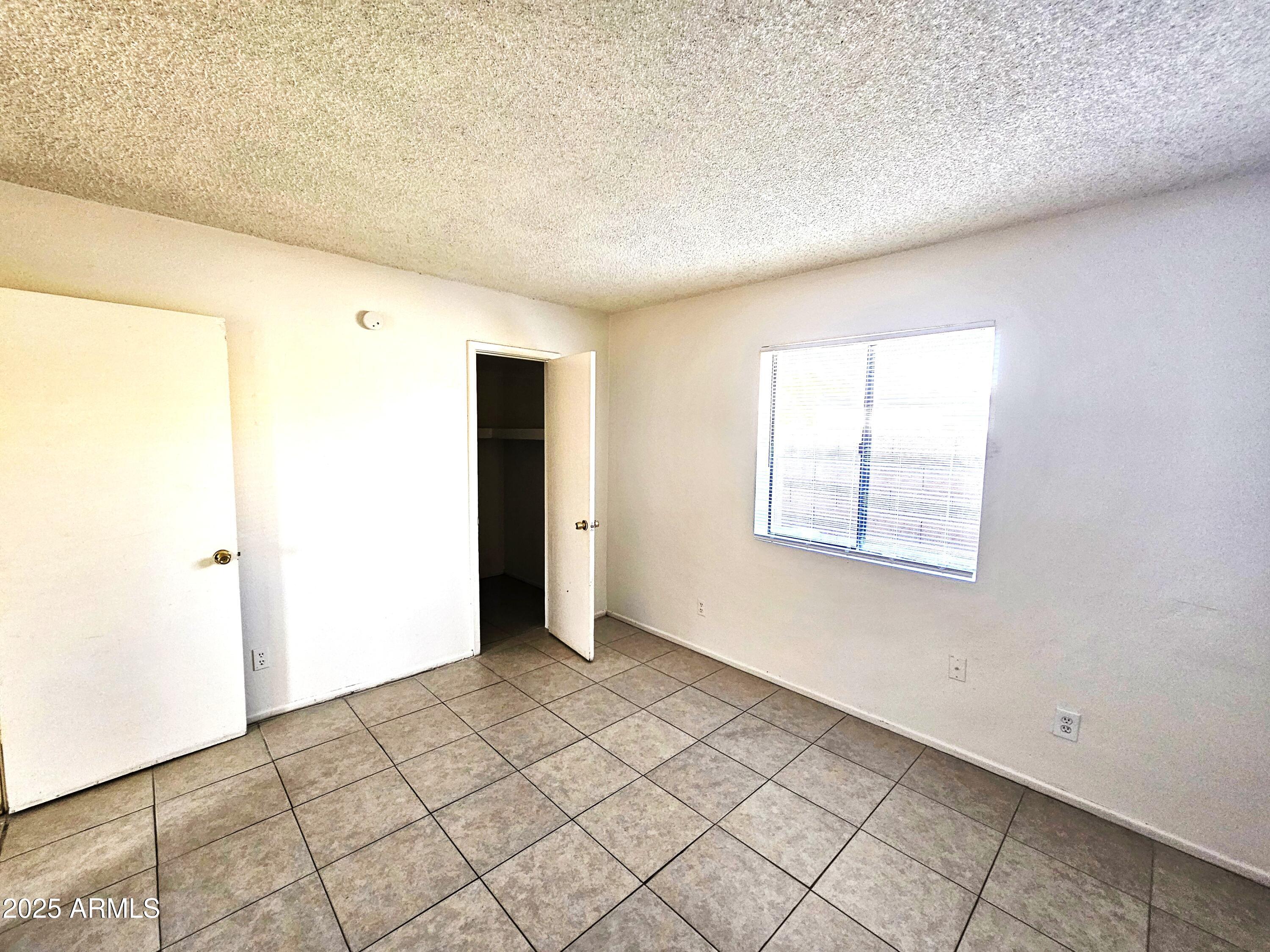 45 North Lyn Rae Drive, Unit 12 Mesa, AZ 85213 - Photo 8 of 24 a view of an empty room and window