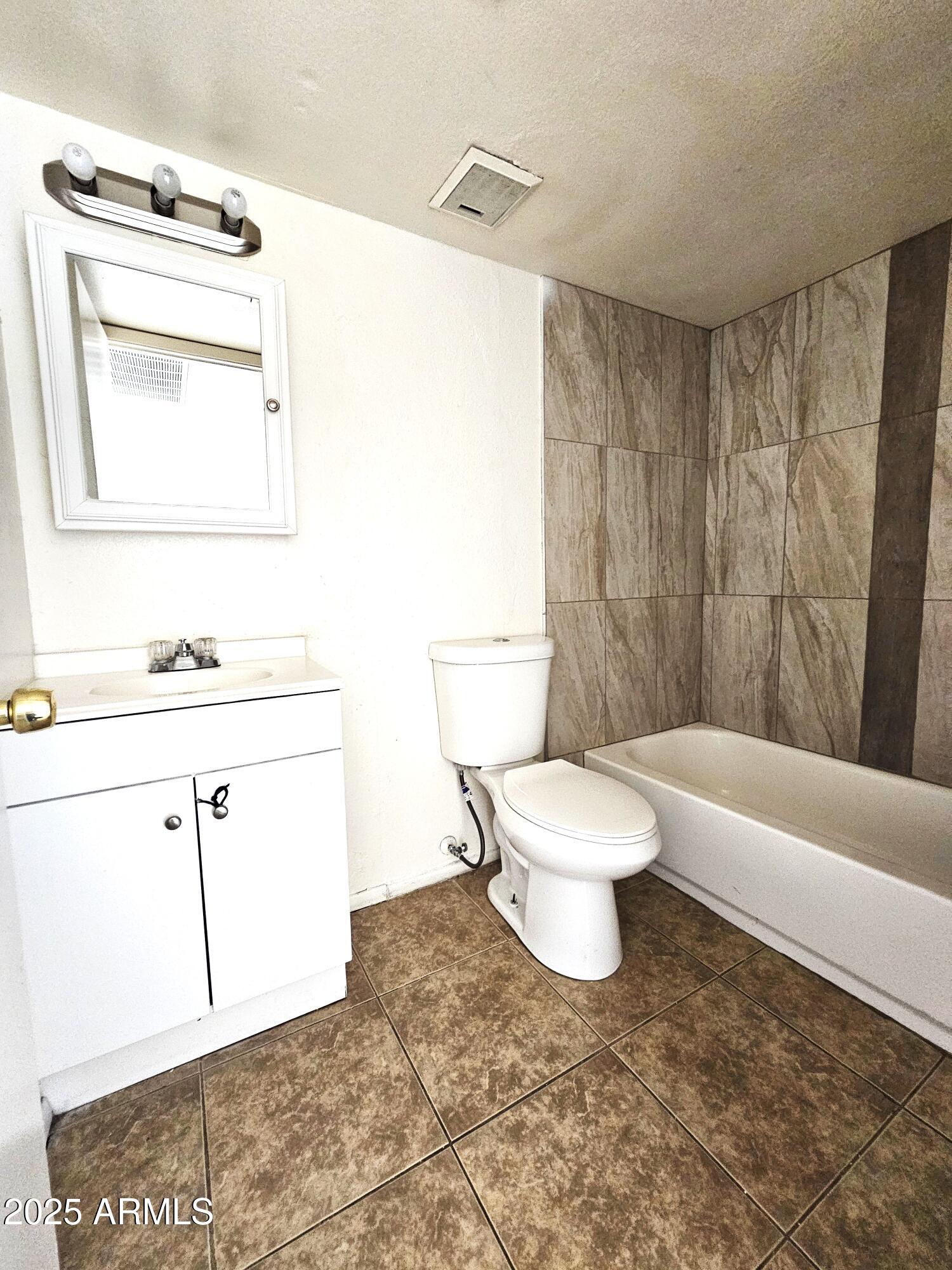 45 North Lyn Rae Drive, Unit 12 Mesa, AZ 85213 - Photo 10 of 24 a bathroom with a toilet a sink and a mirror