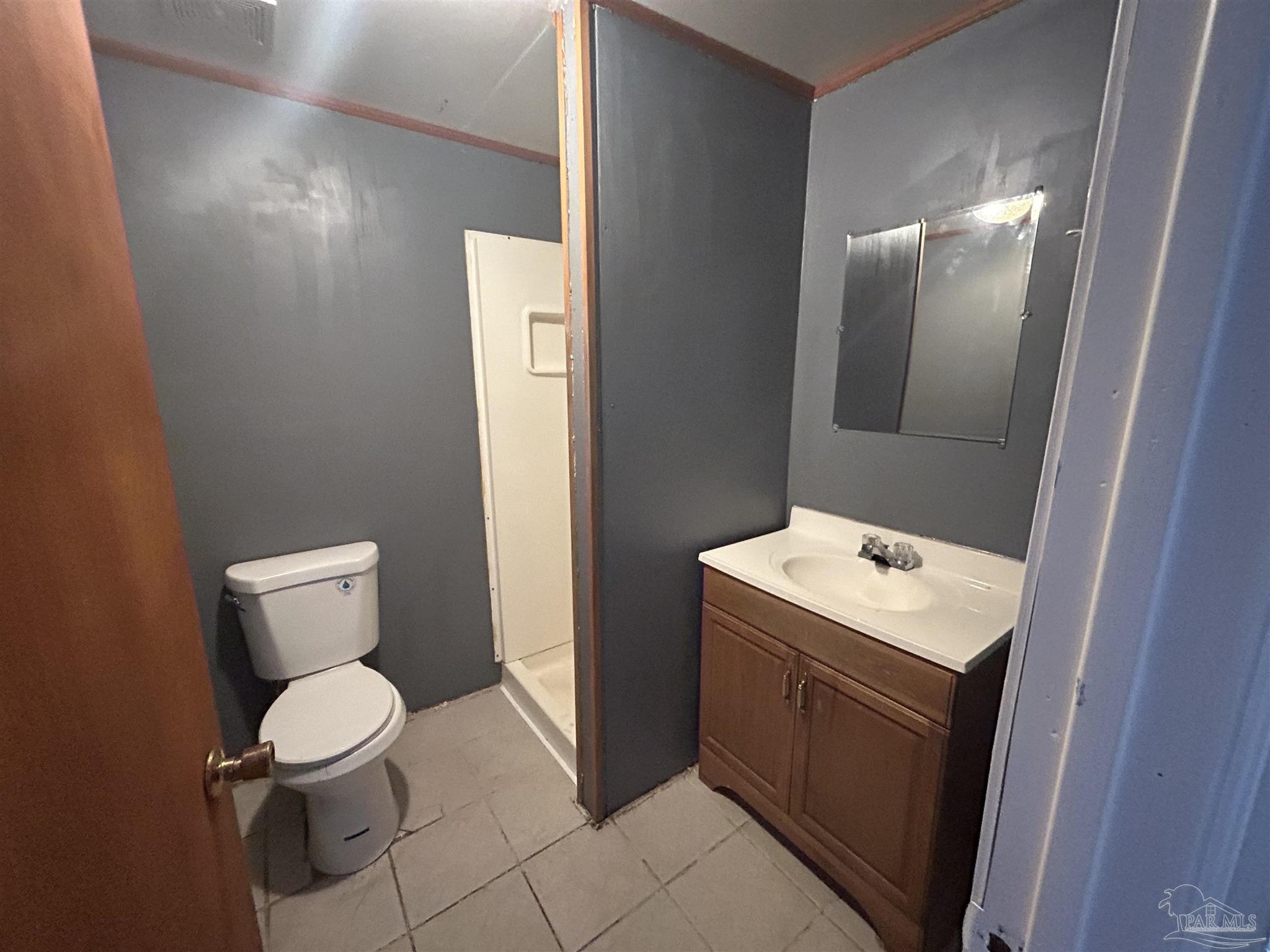 210 Milton Road Pensacola, FL 32507 - Photo 12 of 17 a bathroom with a toilet sink and mirror