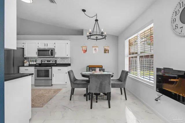 a view of a dining room with furniture window and outside view