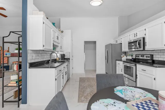 a kitchen with stainless steel appliances granite countertop a sink and a stove