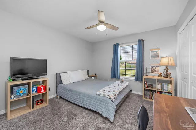 a bedroom with a bed and a desk