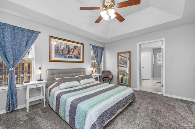 a spacious bedroom with a bed and a flat screen tv